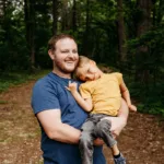Safe in his arms. On Angels' Wings helps document the quiet strength and comfort of family.