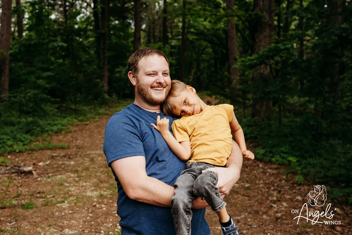 Safe in his arms. On Angels' Wings helps document the quiet strength and comfort of family.